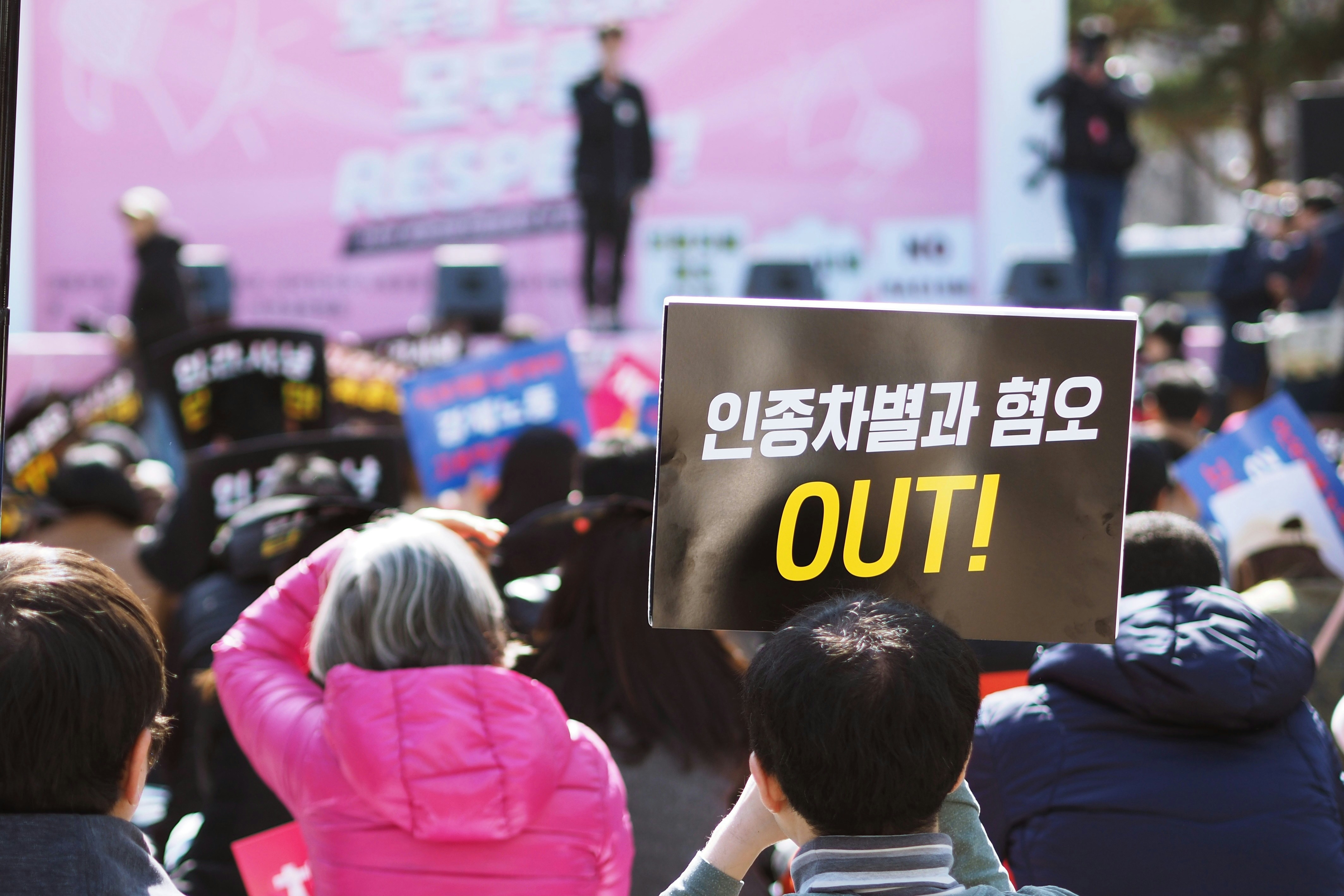 people holding up signs during day